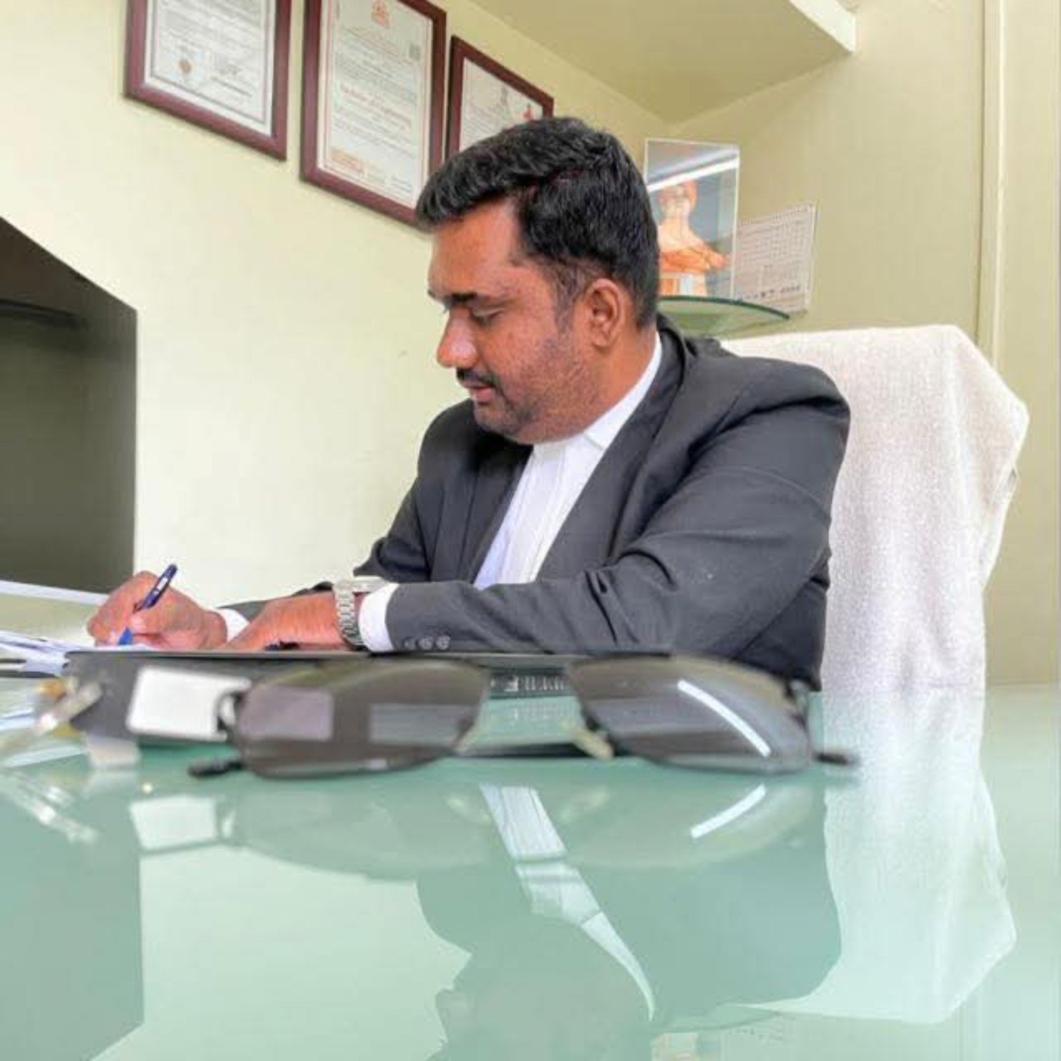 Adv. Mahesh Nagnath Bhatane working at his office desk